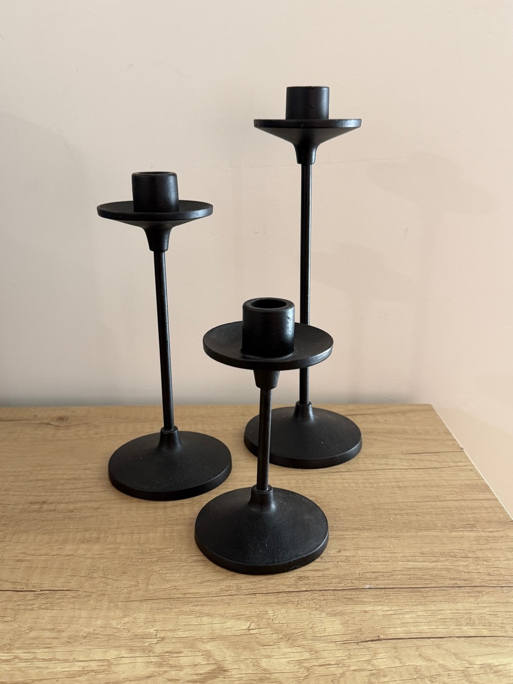 Set of three black metal taper candle holders